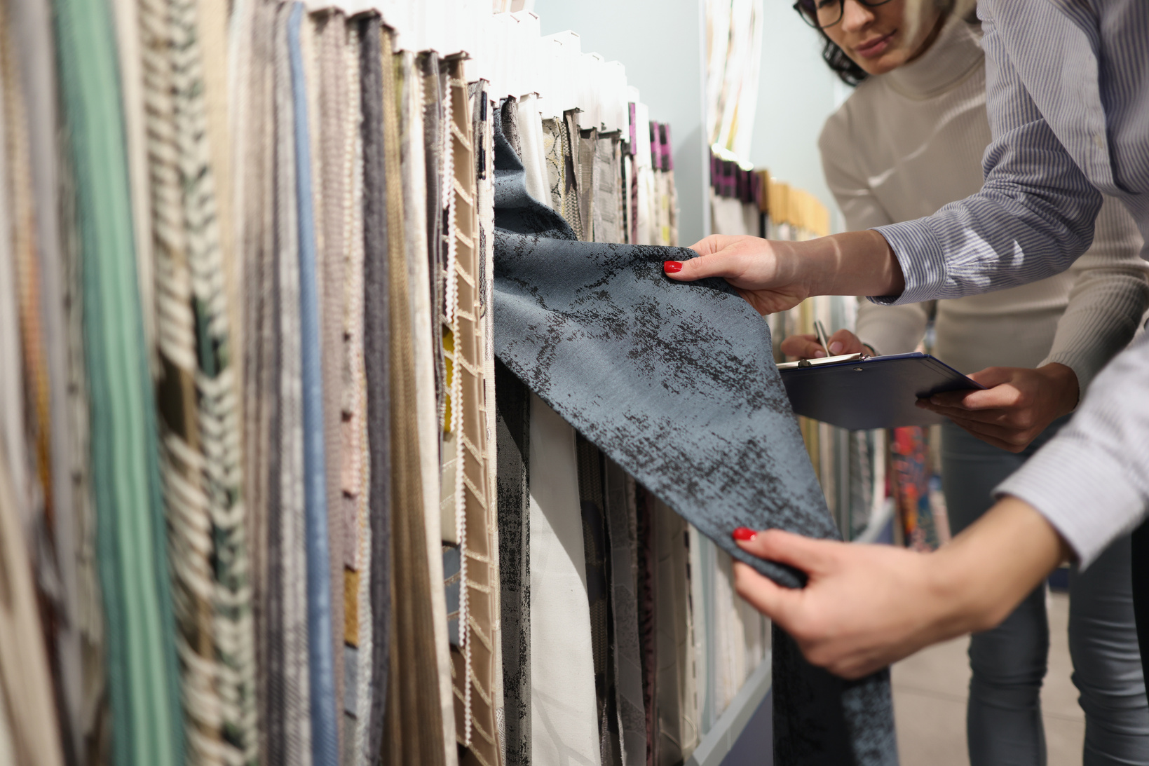 Seller and Buyer Choose Fabrics for Curtains in Showroom